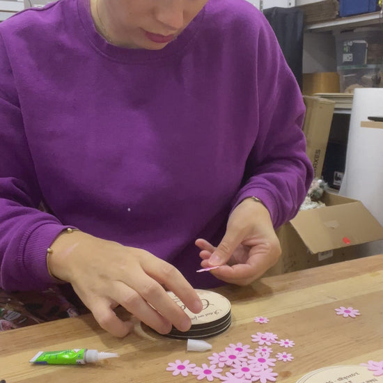 Assemblage des faire part de naissance à la main , collage des fleurs une à une